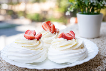 Obraz na płótnie Canvas Homemade meringue dessert Pavlova cake with fresh strawberries and mint. Summer dessert. French cake. Confectionery. Classic dessert. Strawberry dessert