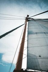 Fototapeta premium sailboat sailing in the ocean with cloudy sky