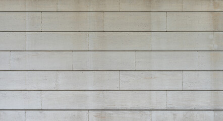 texture of a tiled beige stone wall as background, natural stone wall texture as background. Close-up of a wall clad in limestone