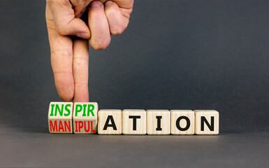 Inspiration or manipulation symbol. Concept words Inspiration and Manipulation on wooden cubes. Beautiful grey background. Psychologist hand. Psychology inspiration manipulation concept. Copy space.