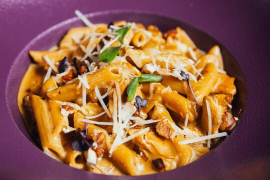 Closeup of a purple plate filled with a delicious pasta