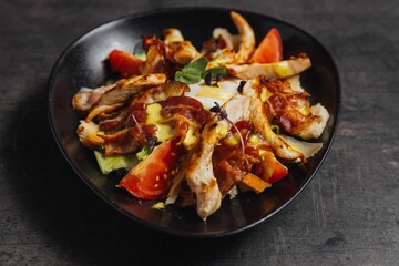 Closeup of a plate of a salad with meat slices