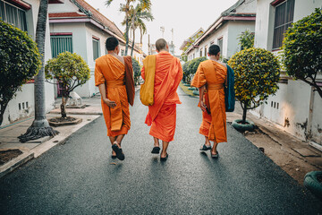 Monks walking down a street in Bangkok