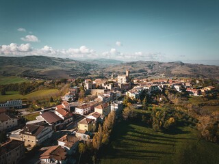 Aerial shot of the beautiful buildings of the medieval Tavoleto village in Italy on a sunny day