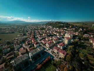 Aerial shot of the beautiful buildings of the medieval Tavoleto village in Italy on a sunny day