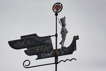 Weather vane on the roof in the form of a ship.