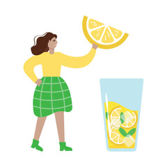 A young woman is holding a huge slice of lemon for a cocktail or lemonade.