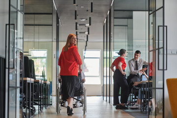 A group of young business people in a modern glass-walled office captures the essence of diversity...