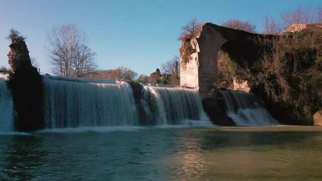 Landscape view of Pontevecchio village waterfall with medieval stone walls in Italy