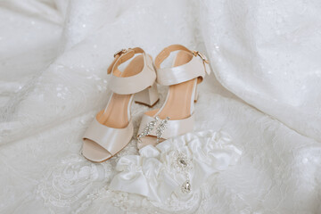 wedding concept. bride's shoes and veil. The bride's garter is white