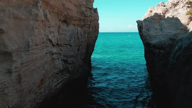 Aerial footage of the Bay of Riaci in Calabria cliffs and crystal Caribbean sea, Italy