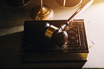 Business and lawyers discussing contract papers with brass scale on desk in office. Law, legal services, advice, justice and law concept picture with film grain effect