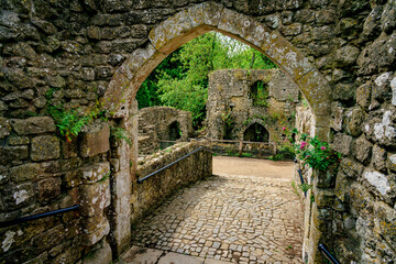 Pathway through an arch at ancient castle ruins in England