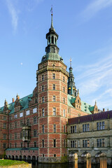 Obraz premium One of the majestic towers of the lakeside facade of Frederiksborg Castle in Hillerod, Denmark
