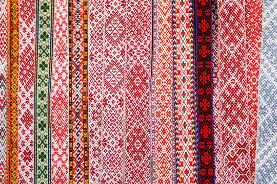 Traditional colorful handmade woven Baltic national patterned fabric belts background