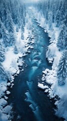 Snowy winter forest and river, top view taken by drone.