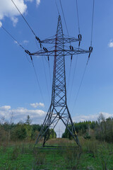 rows of power pylons running through picturesque fields