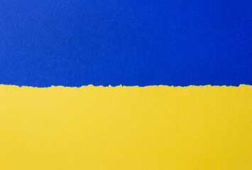 Sheets of blue and yellow cardboard paper with open edges. Copy space, selective focus