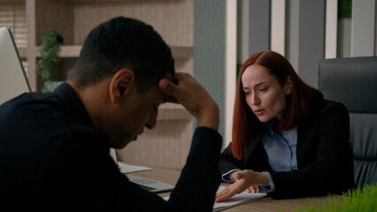 Angry businesswoman displeased leader screaming at office worker demanding boss annoyed at employee work contract problem document mistakes shout multiracial woman and man quarrel in business company