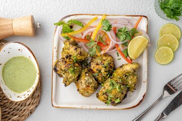 Plate with a delicious looking fried chicken dish surrounded by a savory sauce