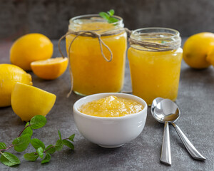 Freshly made homemade lemon jam in glass jars.