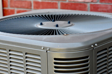 Outdoor air conditioning unit with brick wall background