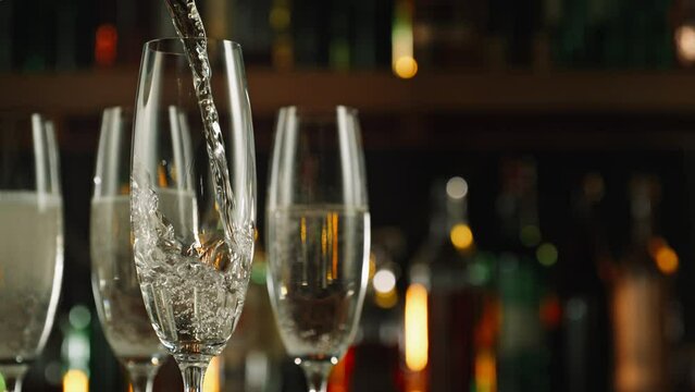 Super Slow Motion Shot of Pouring Champagne Wine into Glass Before Bar at 1000fps.