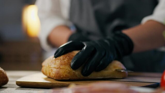 A toast, a professional chef prepares Cooking a sandwich in an authentic sandwich bar. an efficient hamburger man is at work learning new techniques for making sandwiches, delivering