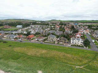 Fototapeta na wymiar Aerial view of a residential area with lush green grass in Scotland
