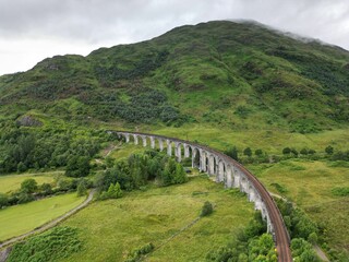 Aerial view of train tracks winding in Glenfinnan Viaduct in Scotland's Highlands