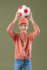 Fototapeta premium Little boy with soccer ball on color background