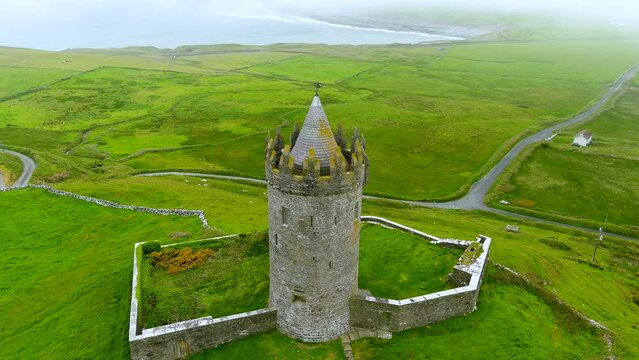 Aerial foggy view of Doonagore Castle, iconic landmark, County Clare, Ireland