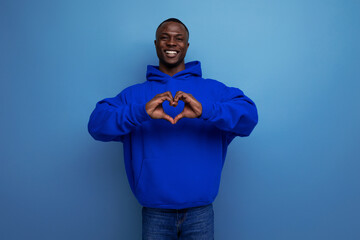 close-up of a 25 year old dark-skinned African man in a sweatshirt with a hood with a model...