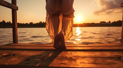 Close up of girl s legs on wooden pier sunset on river beach. silhouette concept