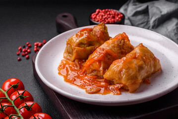 Delicious dolma in tomato sauce with carrots, onions, salt, spices and herbs