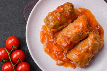 Delicious dolma in tomato sauce with carrots, onions, salt, spices and herbs