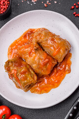 Delicious dolma in tomato sauce with carrots, onions, salt, spices and herbs