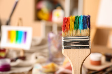 Brush with paints in artist's studio