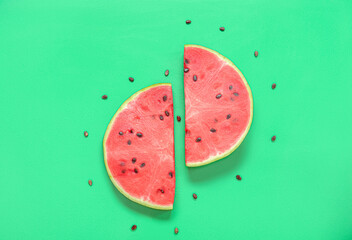 Composition with pieces of ripe fresh watermelon and seeds on green background