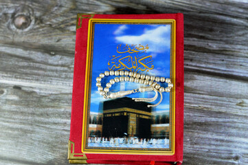 Makkah al-Mukarramah or Mecca the honored Quran  textbook, with a blurry glowing picture of Al...