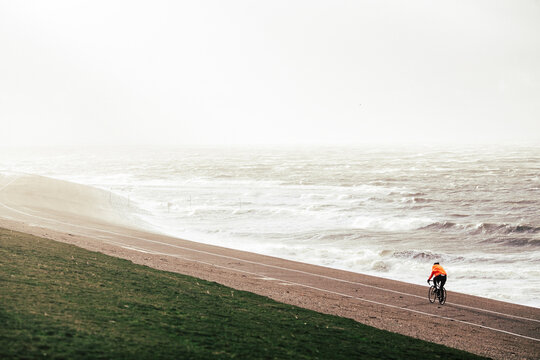 Cyclist riding near the sea 