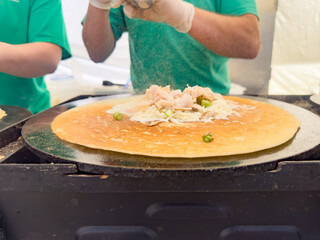 A view of a worker preparing a crepe.