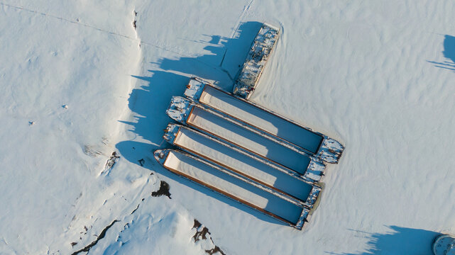 vessels frozen in the middle of an icy river