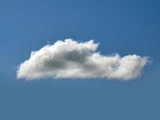 Single white cloud over blue sky background. Fluffy cumulus cloud shape