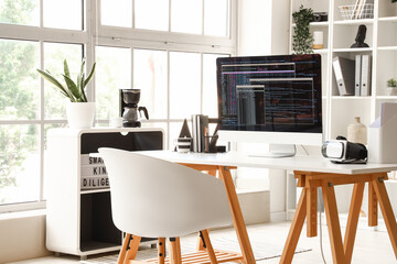 Computer monitor with programming code at workplace in office