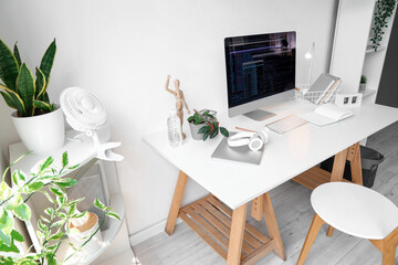 Programmer's workplace with computer in interior of light office