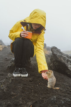 Girl with a toothbrush and feeding a gopher