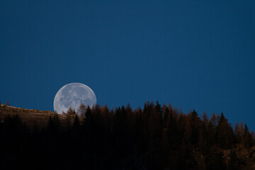 The moon sets from the mountain a Branzi Bergamo