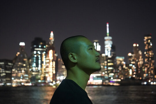 profile of a man on the background of the city at night