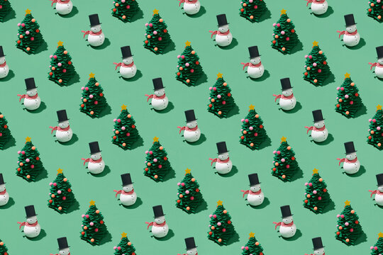 Creative Christmas pattern made of snowmen and paper pine tree
